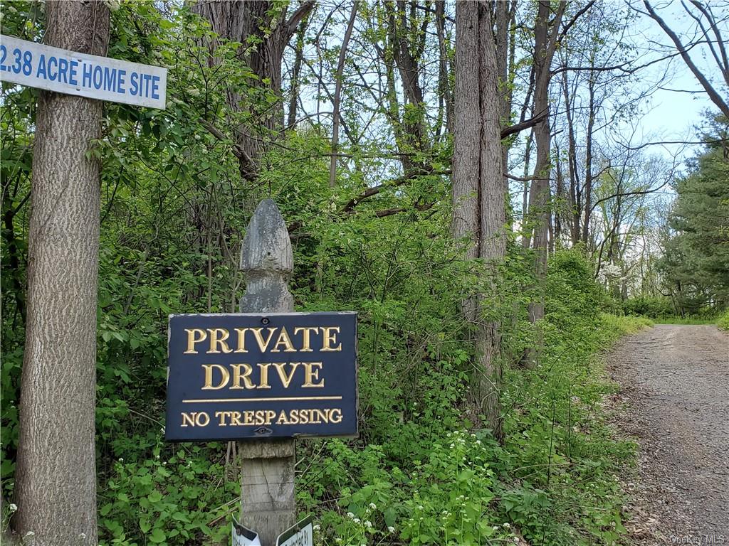 a sign broad in front of red brick house