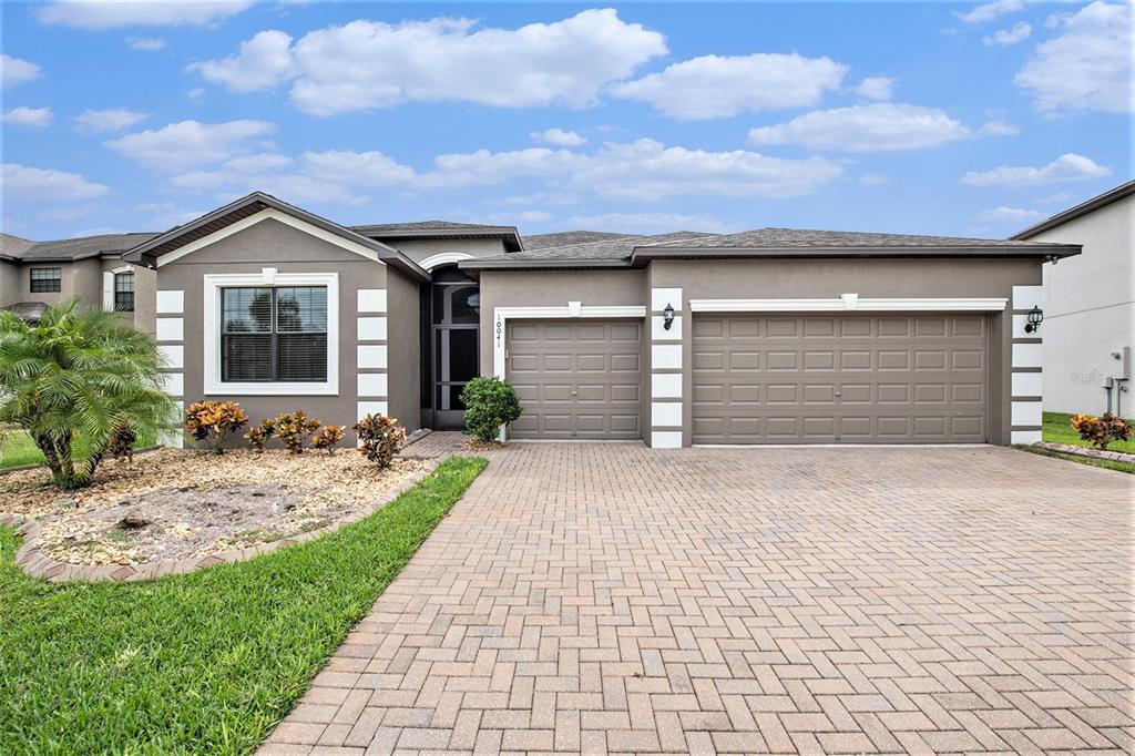 a front view of a house with a yard and garage