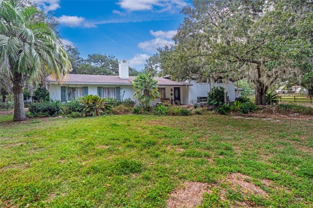 a view of house with yard and outdoor space