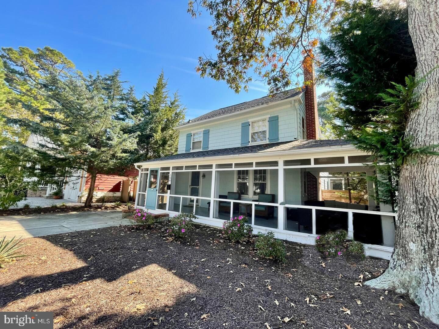 a view of a house with a large window and a yard