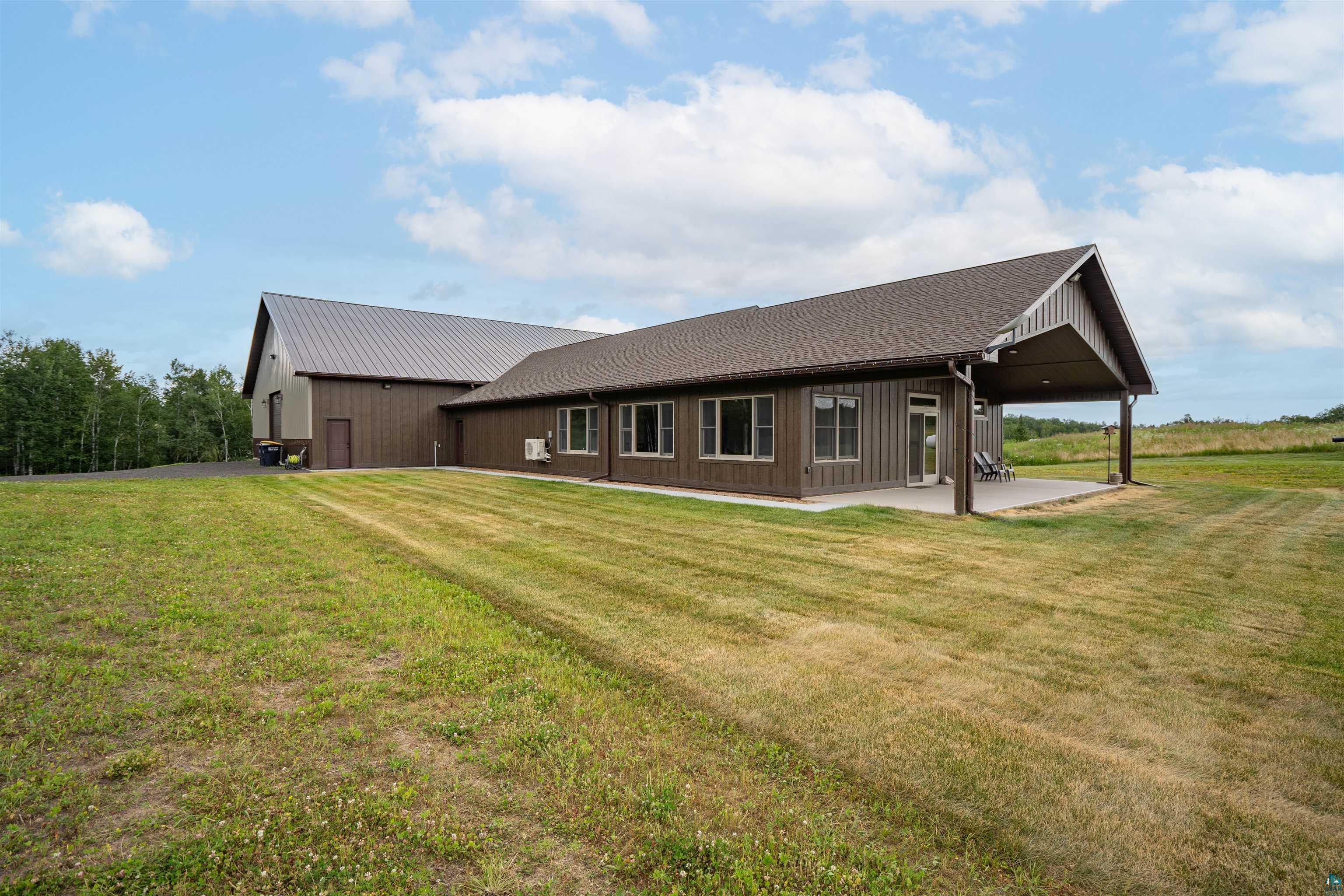 Rear view of property featuring a patio area and a lawn