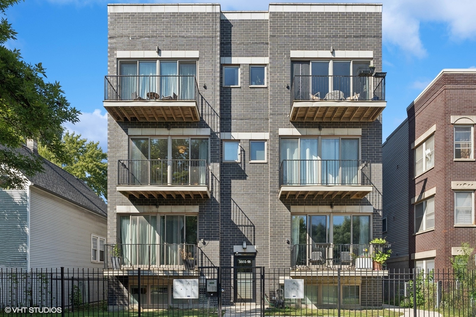 a front view of a residential apartment building with a yard