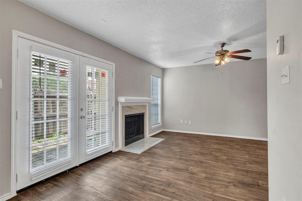 wooden floor in an empty room with a fireplace