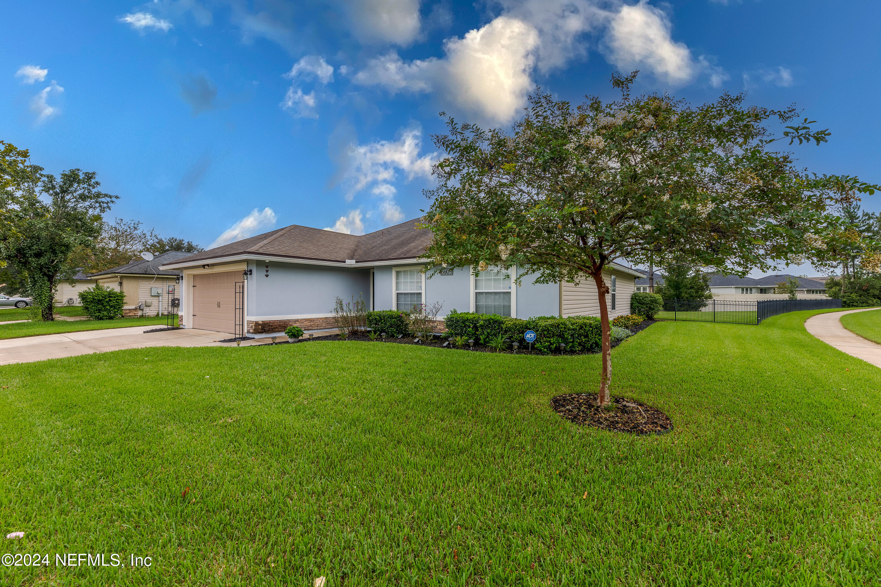 a front view of a house with garden