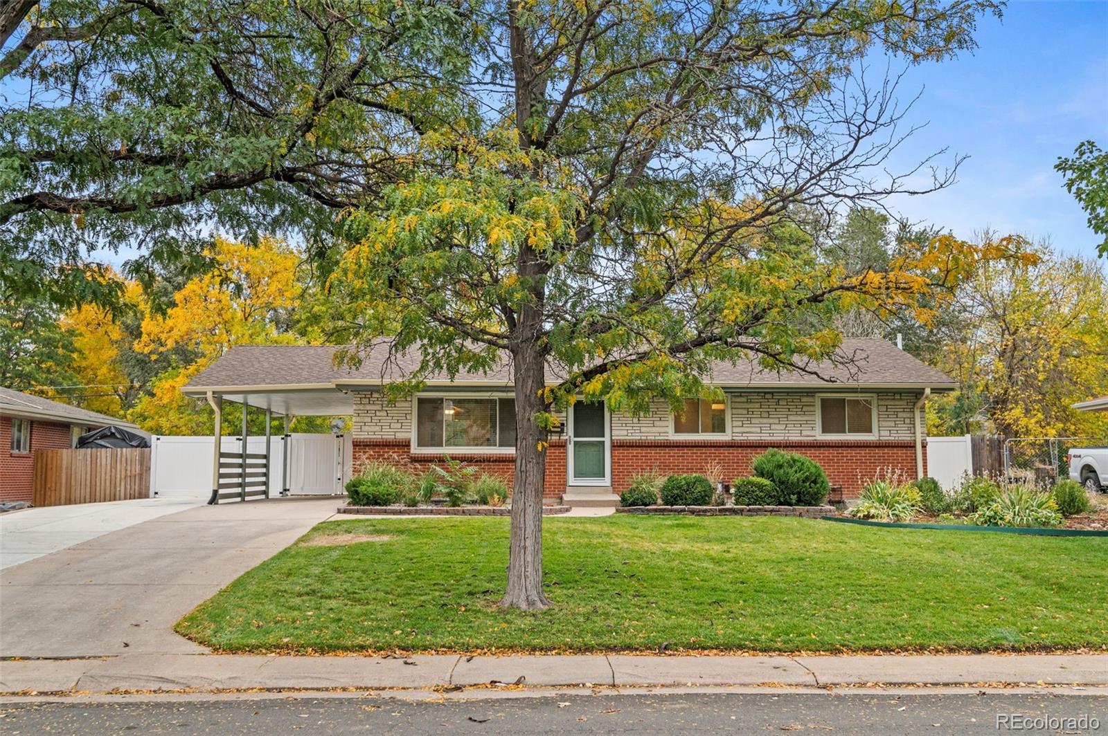 a front view of house with yard and green space