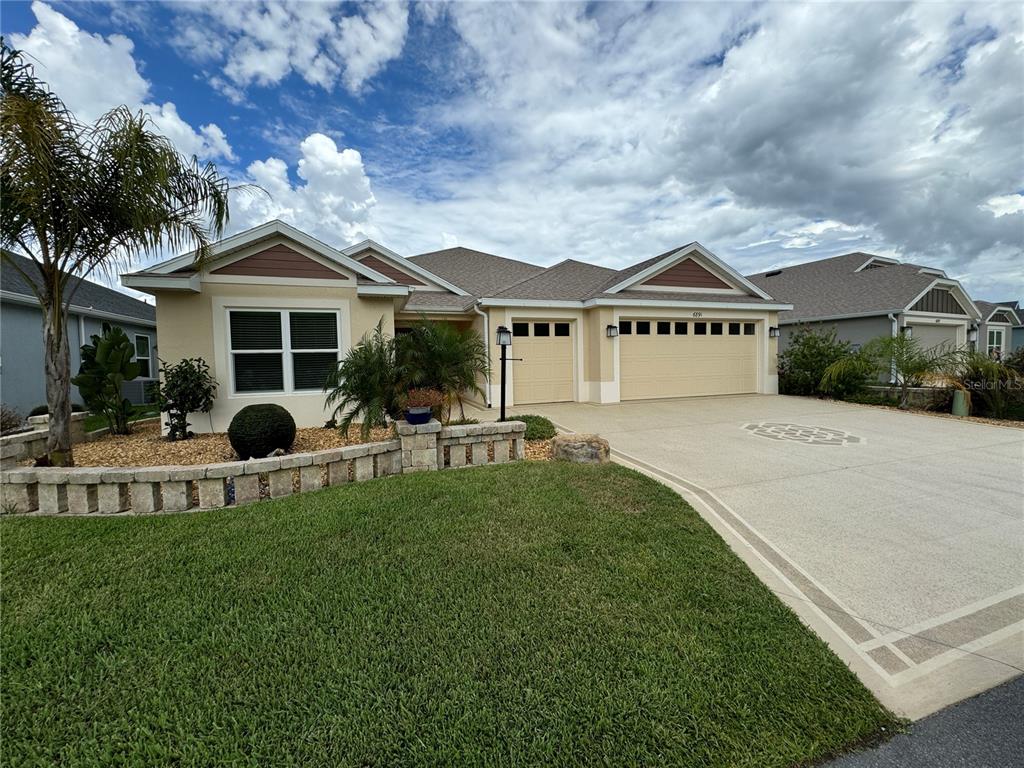 a front view of a house with a garden and plants