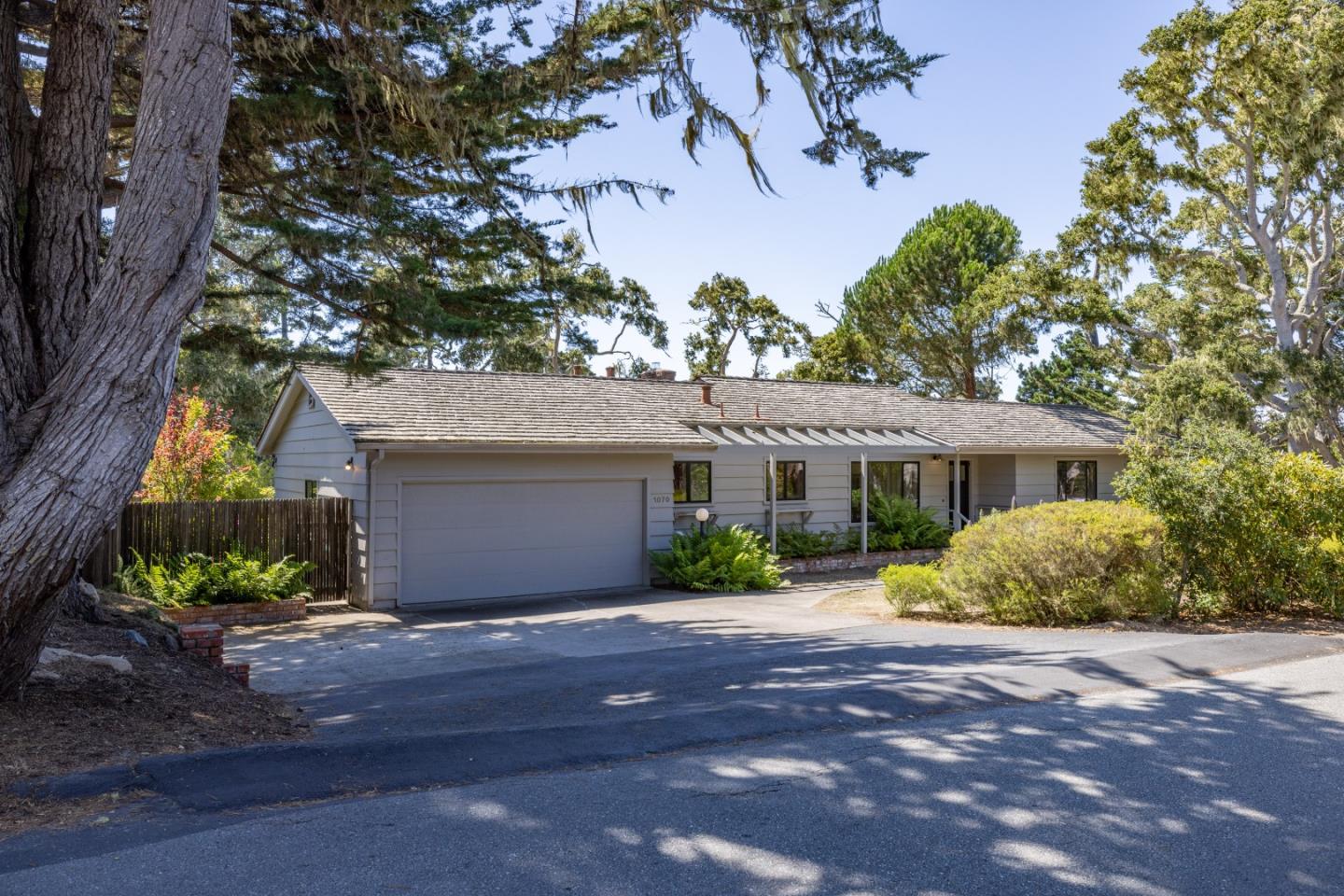 a front view of a house with a yard and a garage