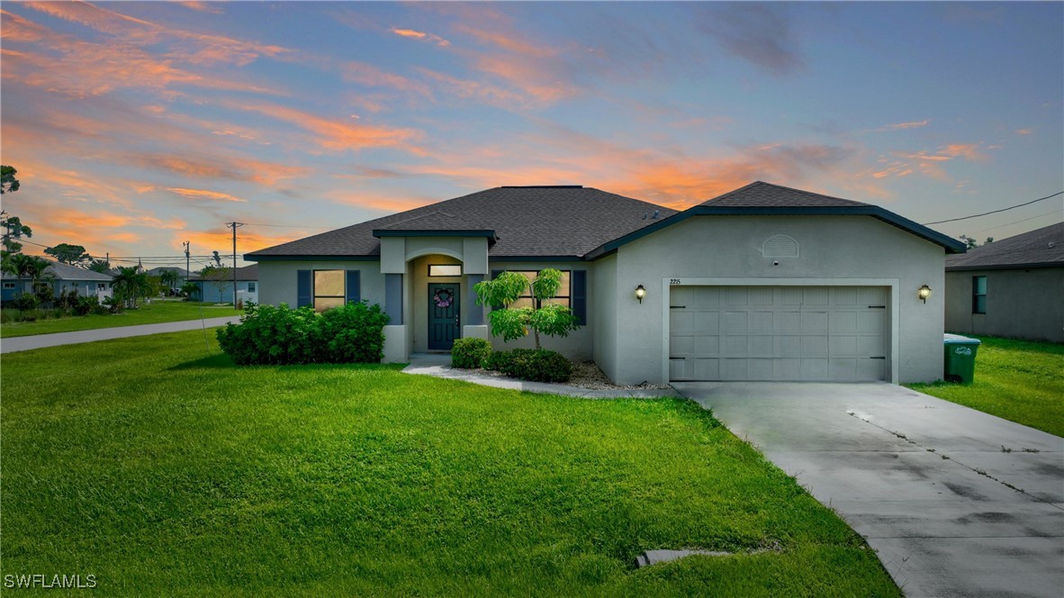 a front view of a house with a yard and garage