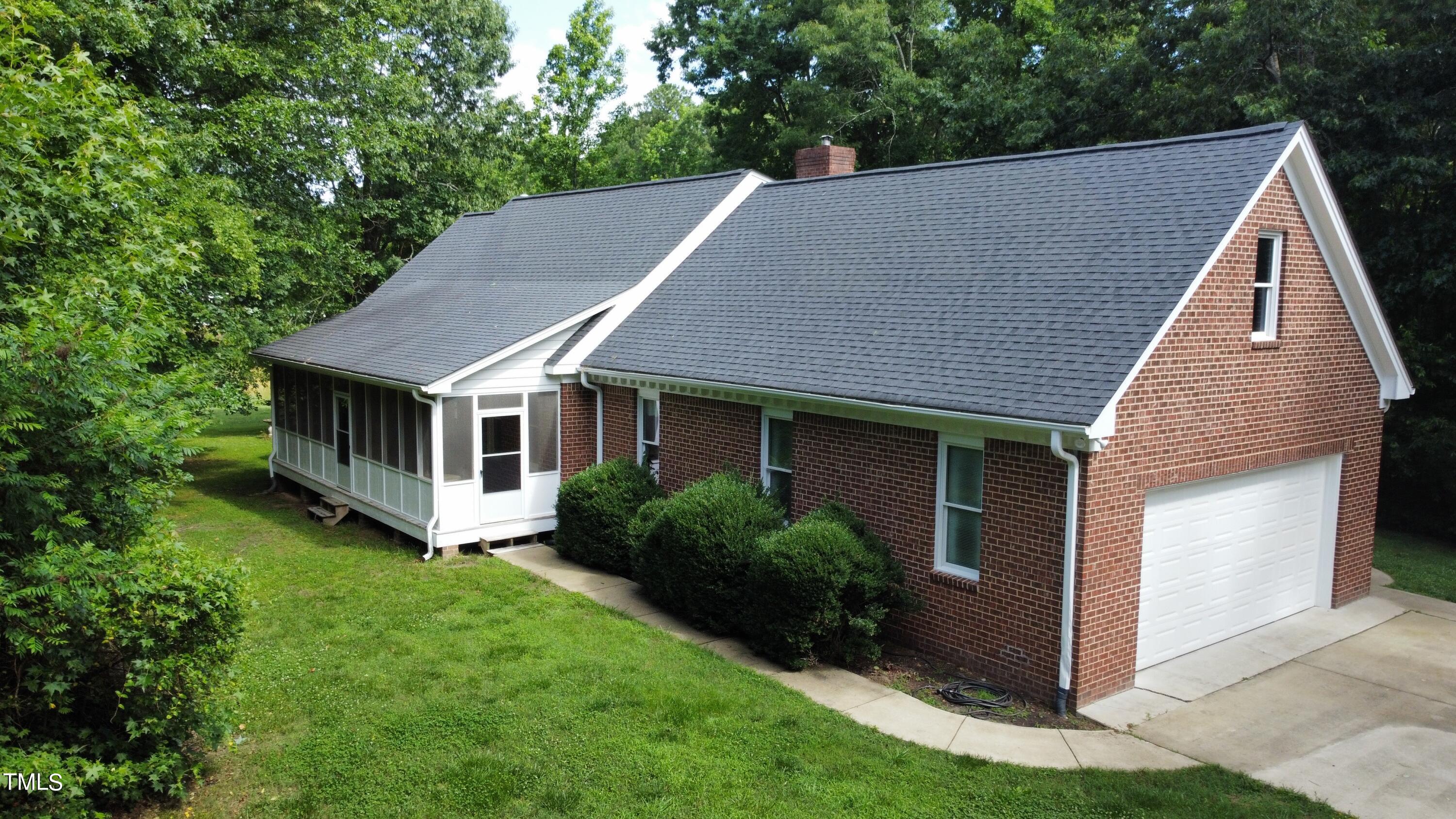 a aerial view of a house with yard and sitting area