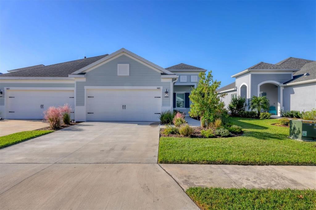 a front view of a house with a yard and garage