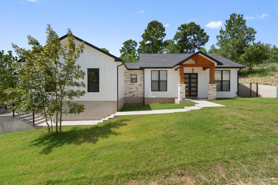 a front view of house with yard and green space