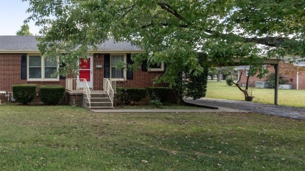 a view of a house with a yard and tree s