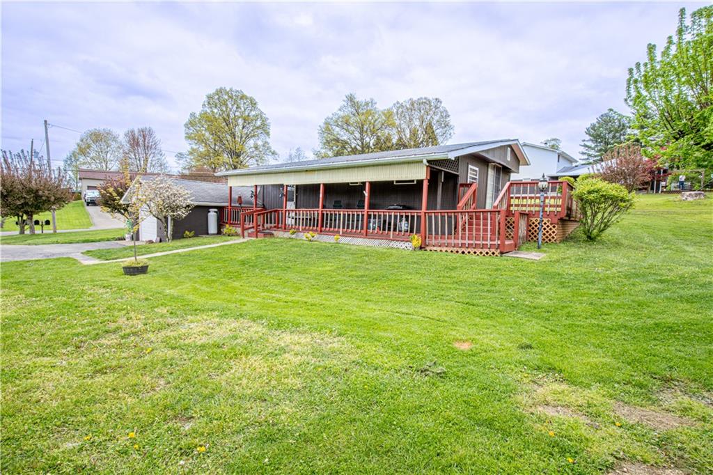 a view of a house with a yard and sitting area