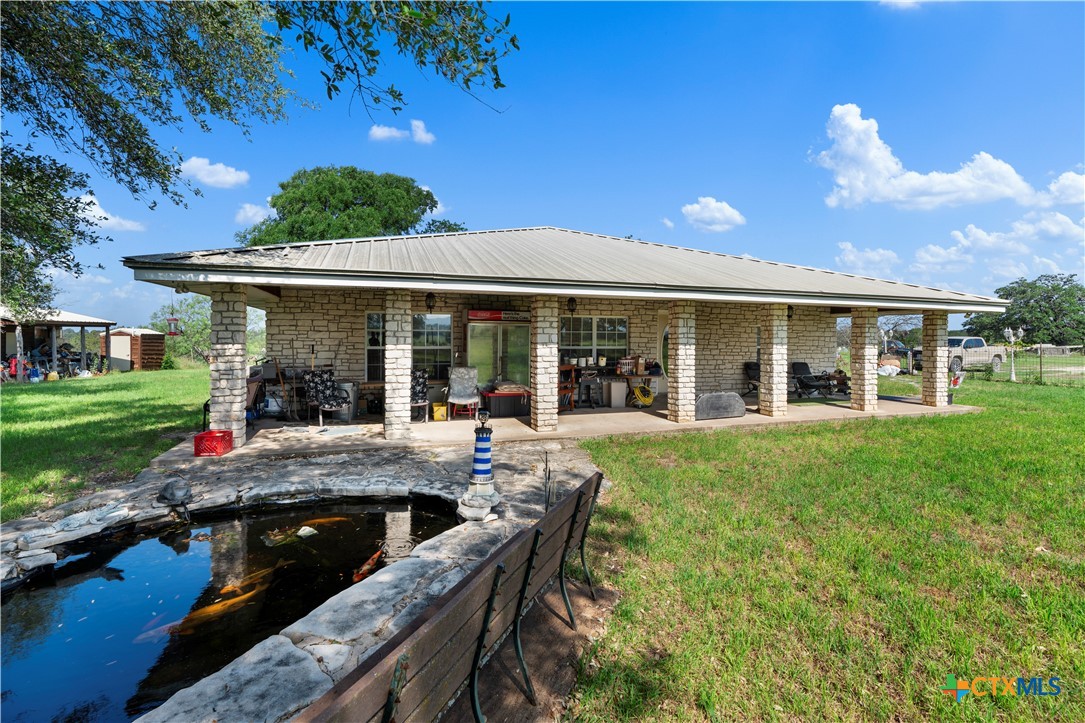 a view of an house with backyard porch and sitting area