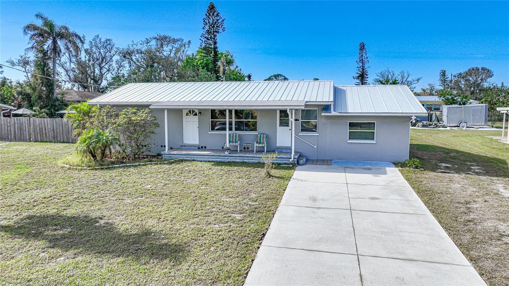 Front of home with nice long porch to look at Gottfried Creek