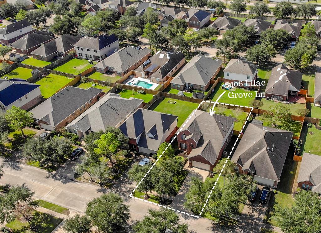 an aerial view of residential house with outdoor space and swimming pool