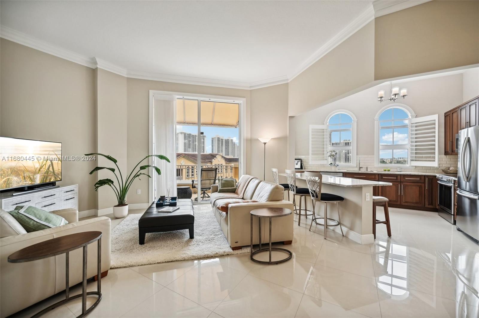 a living room with furniture a flat screen tv and a large window