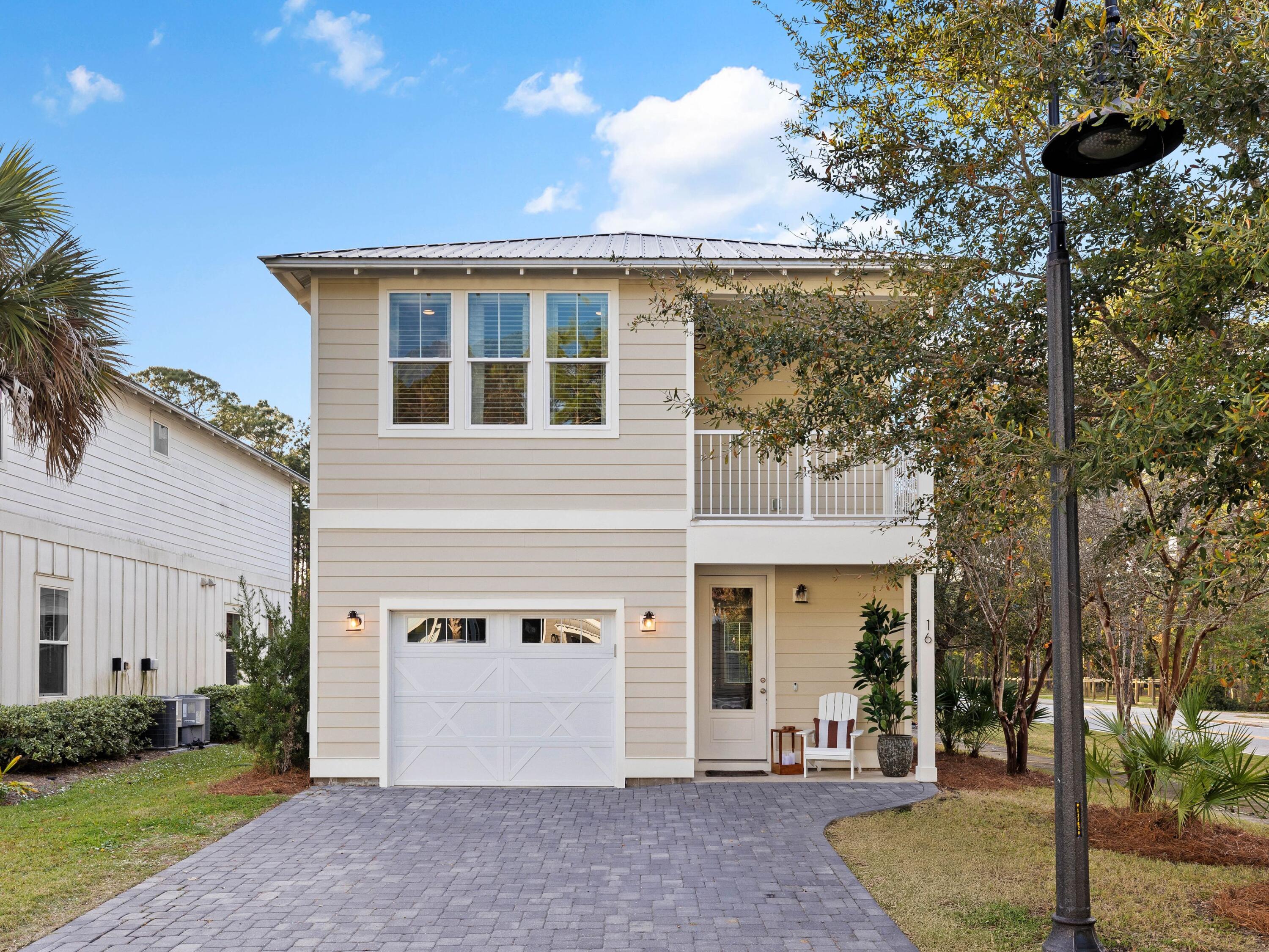 a view of a house with a patio and a yard