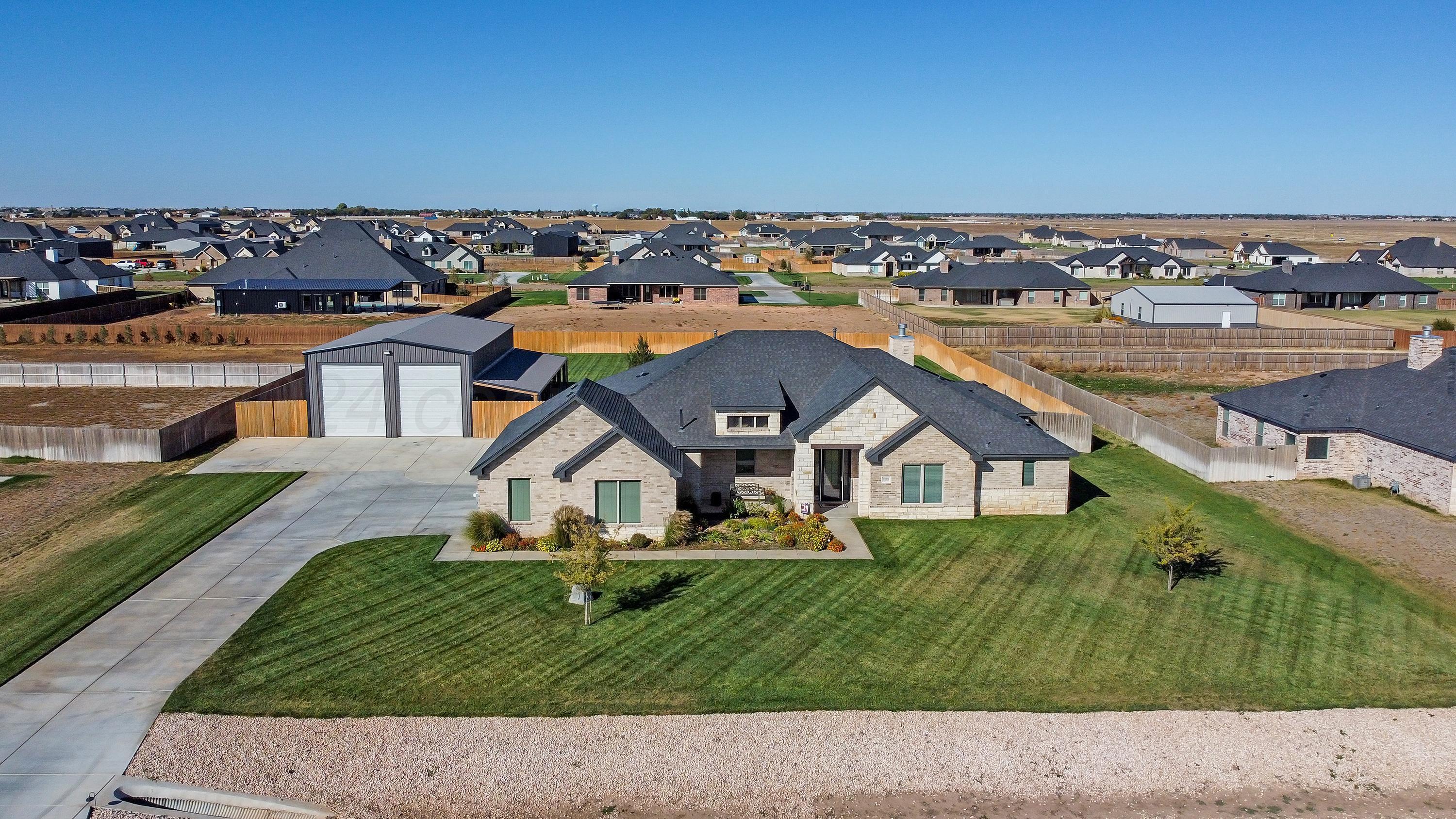 an aerial view of a house with a yard