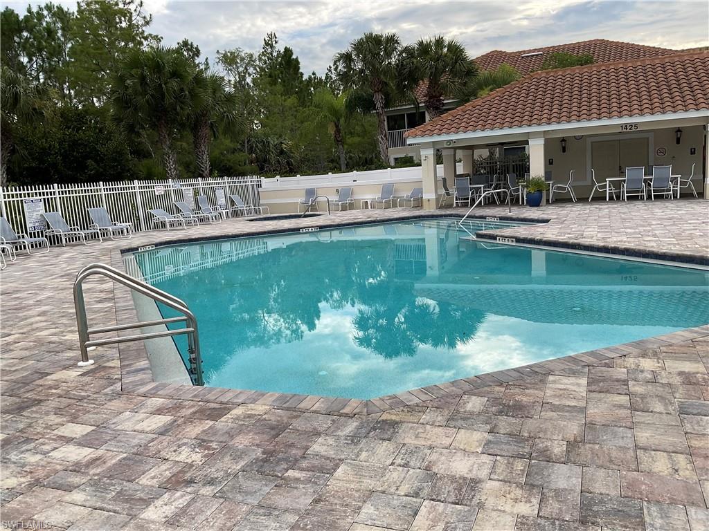 a swimming pool with outdoor seating and yard