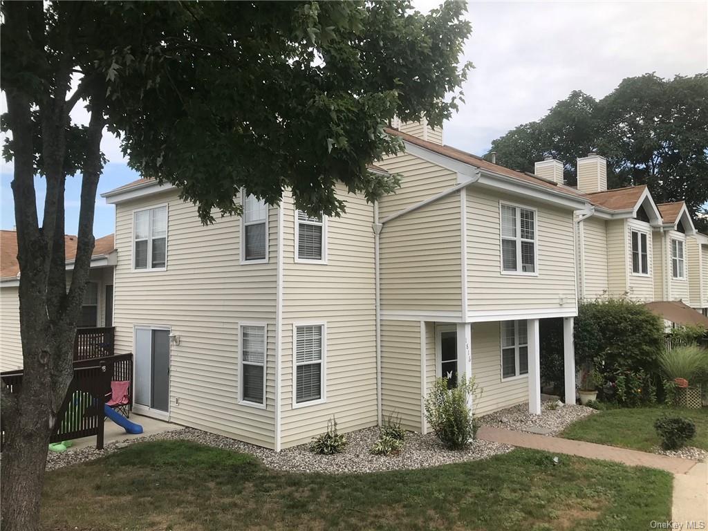 Rear view of house with a lawn