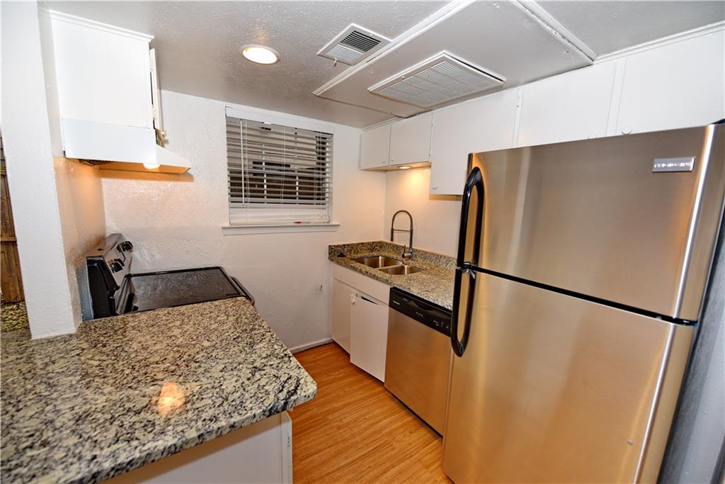 a kitchen with a refrigerator and a sink