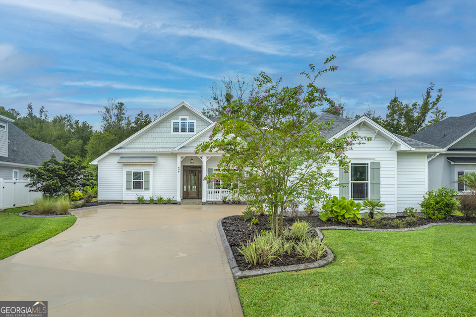 a front view of a house with a garden