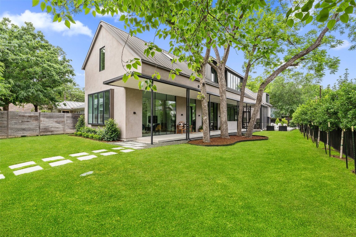 a view of a house with a yard patio and swimming pool