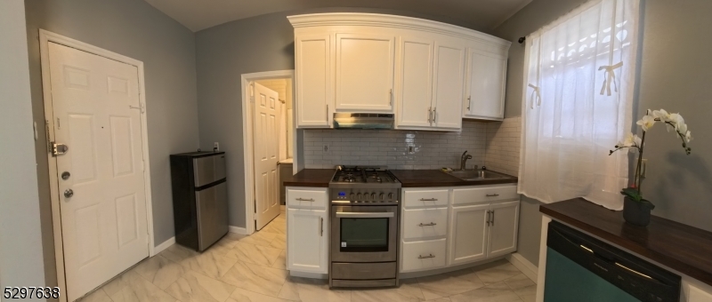 a kitchen with stainless steel appliances granite countertop a stove and a refrigerator