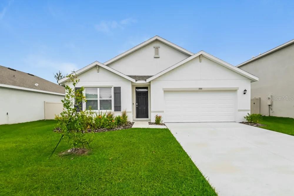 a front view of house with yard and green space