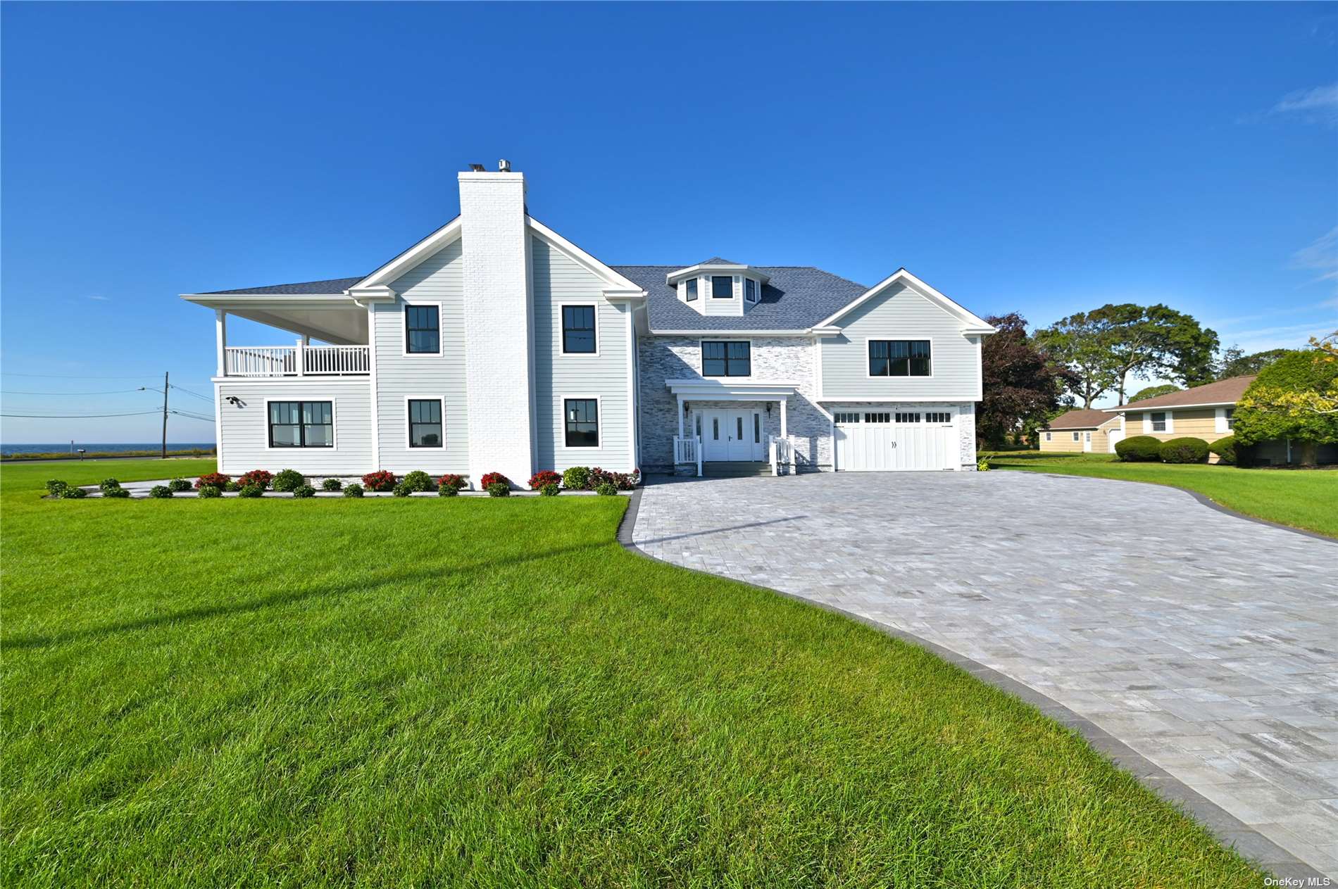 a front view of a house with a yard and trees