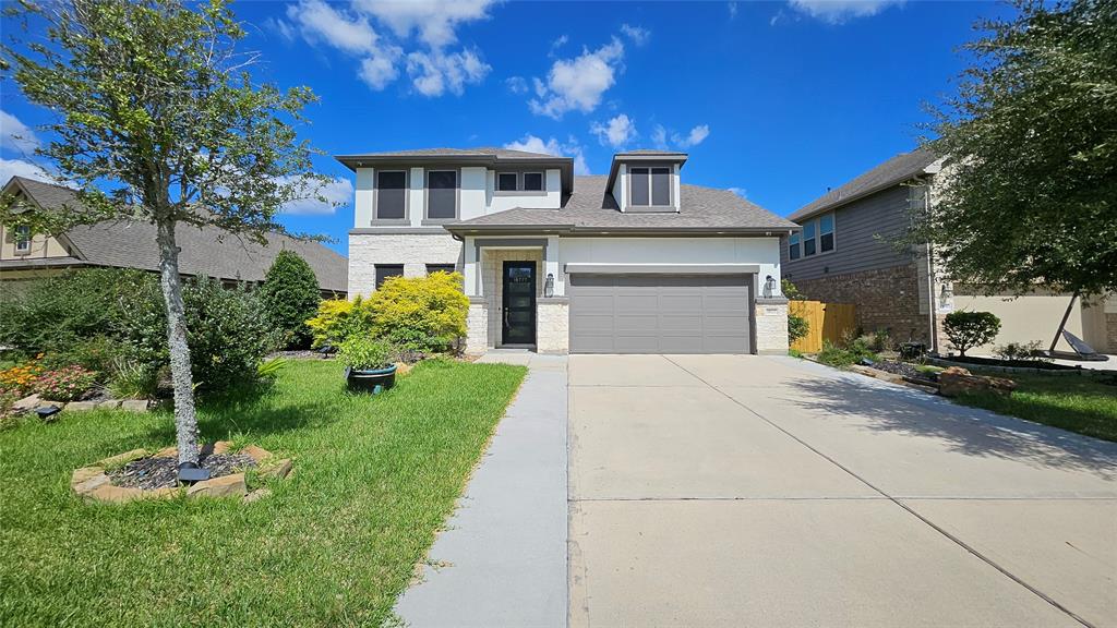 a front view of a house with a yard and garage