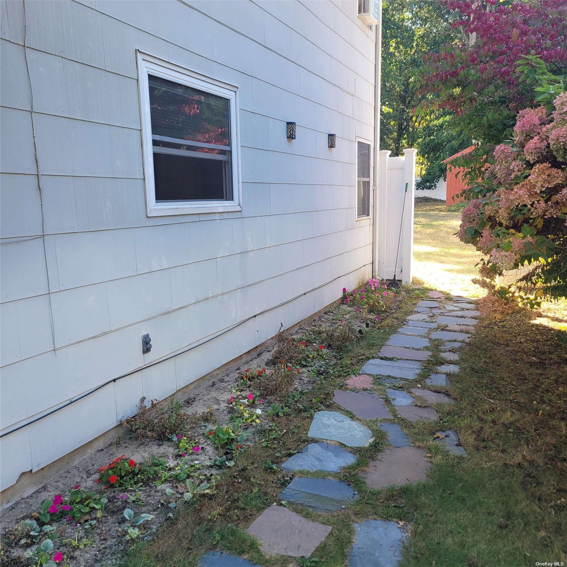 a view of a pathway of a house with a yard