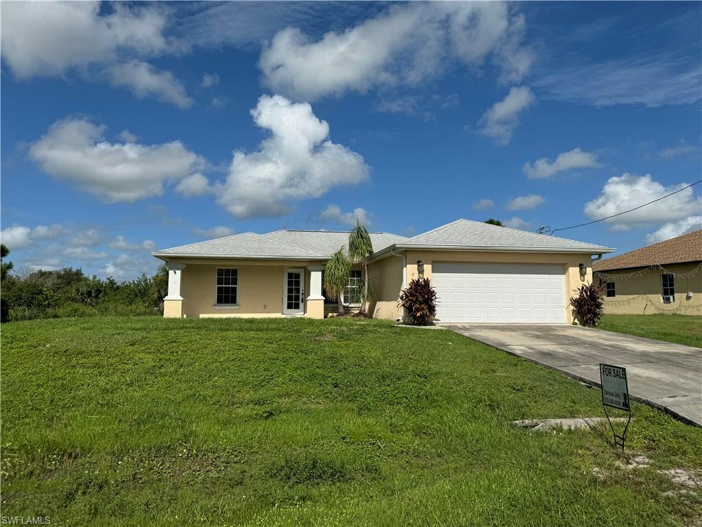 a front view of a house with a yard and garage