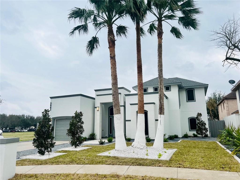 a front view of multiple houses with yard