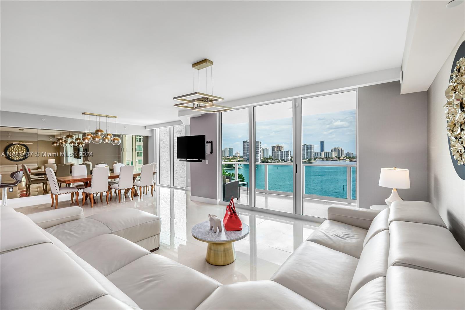 a living room with furniture and a floor to ceiling window