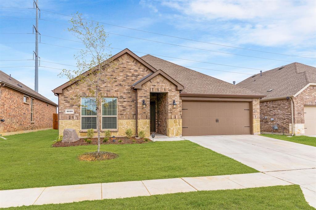 a front view of a house with a yard and entertaining space