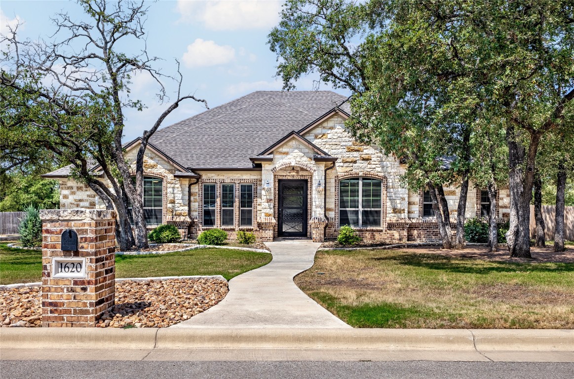 a front view of a house with garden