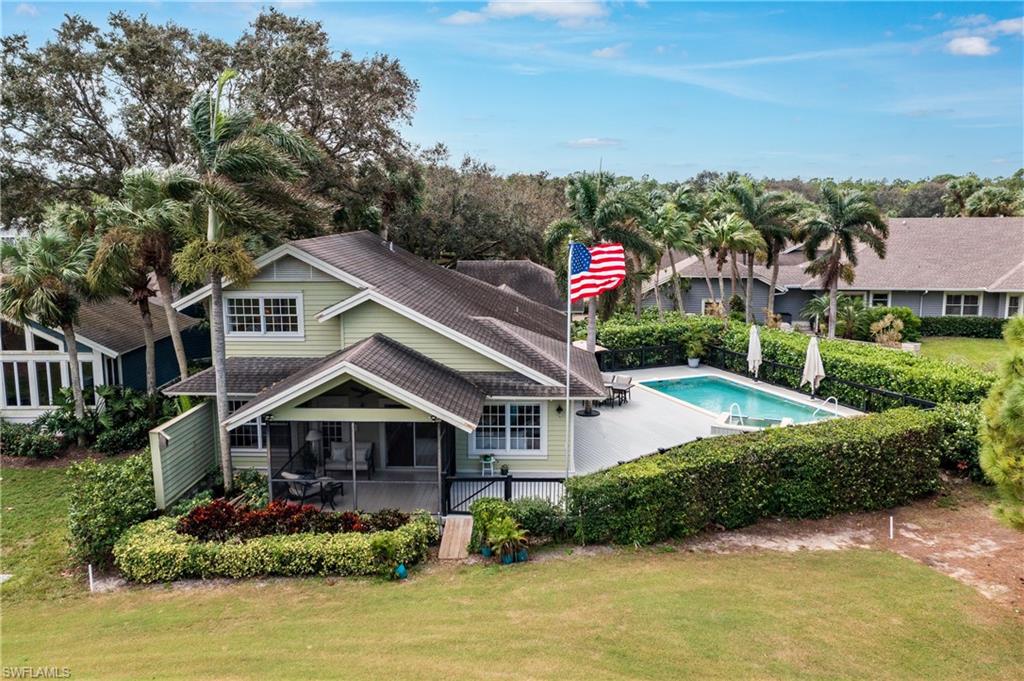 Rear view of property featuring a screened Lanai