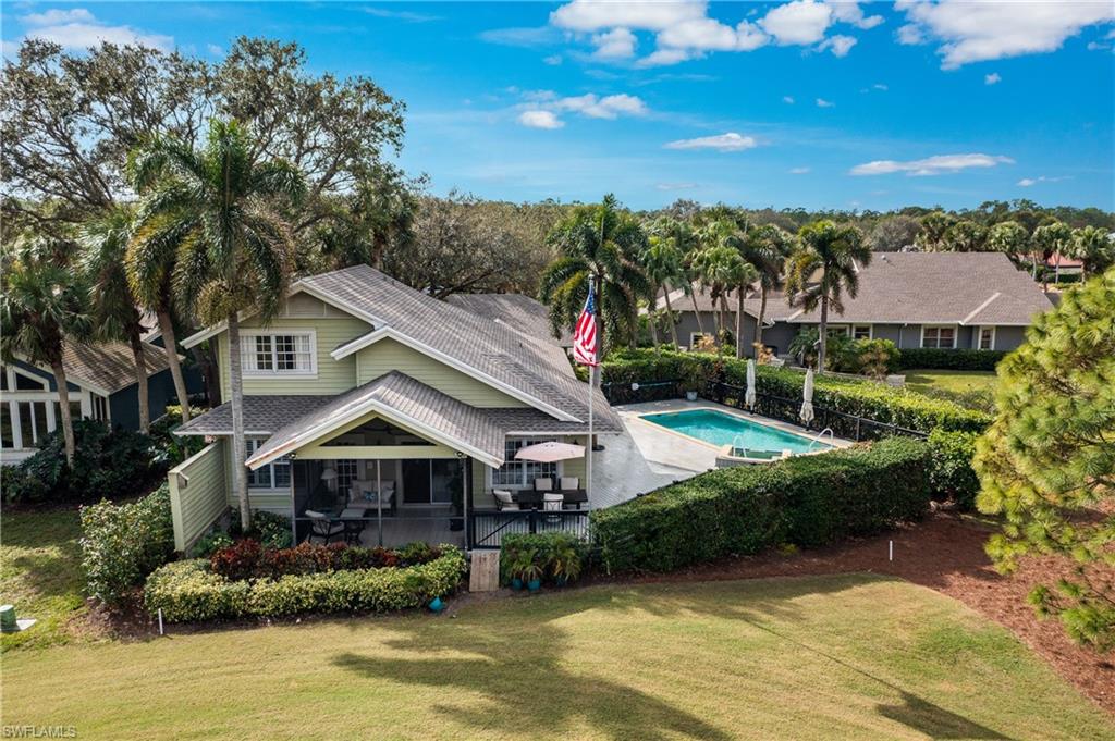 Rear view of property featuring a screened Lanai