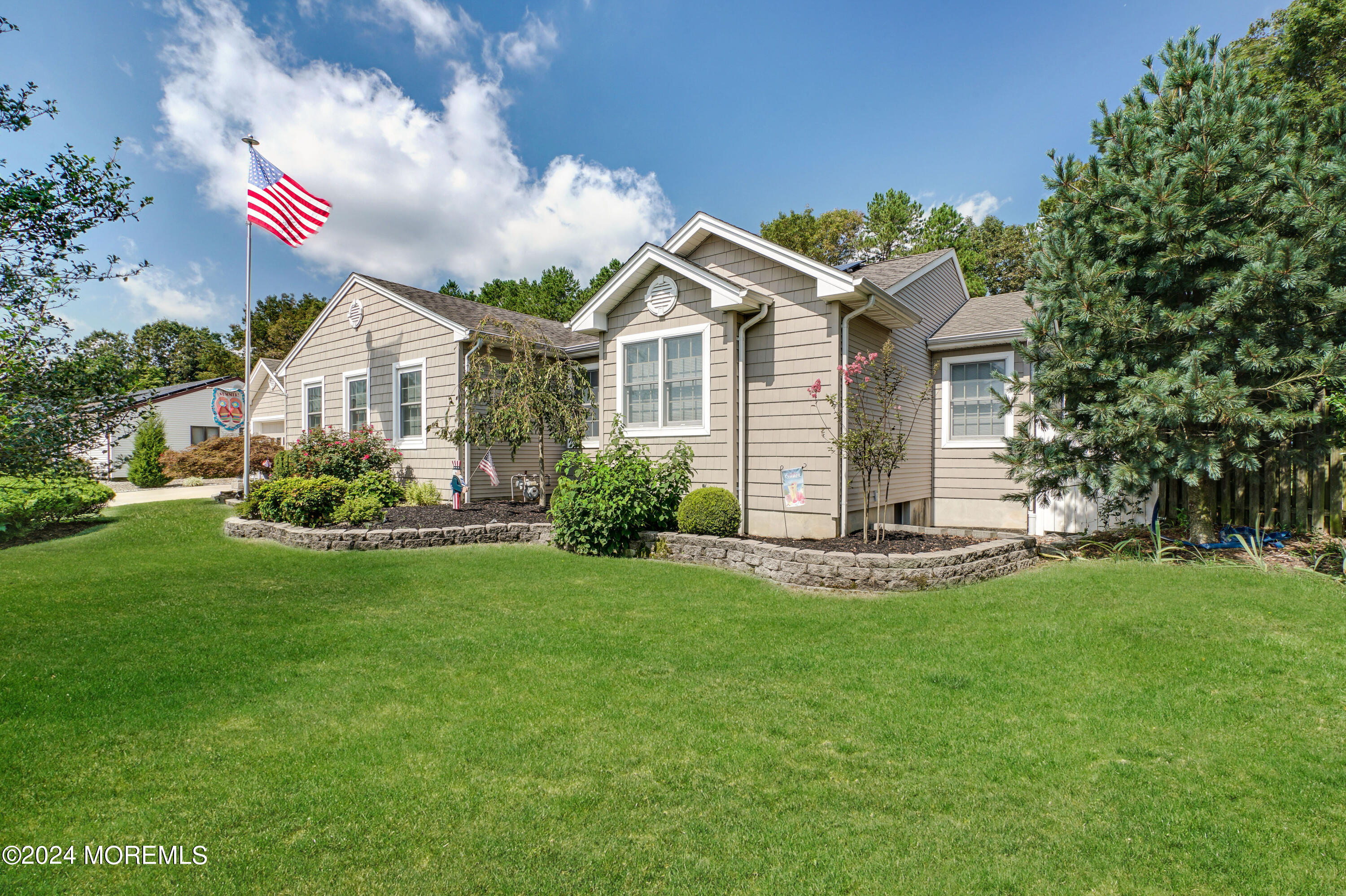 a front view of house with yard and green space