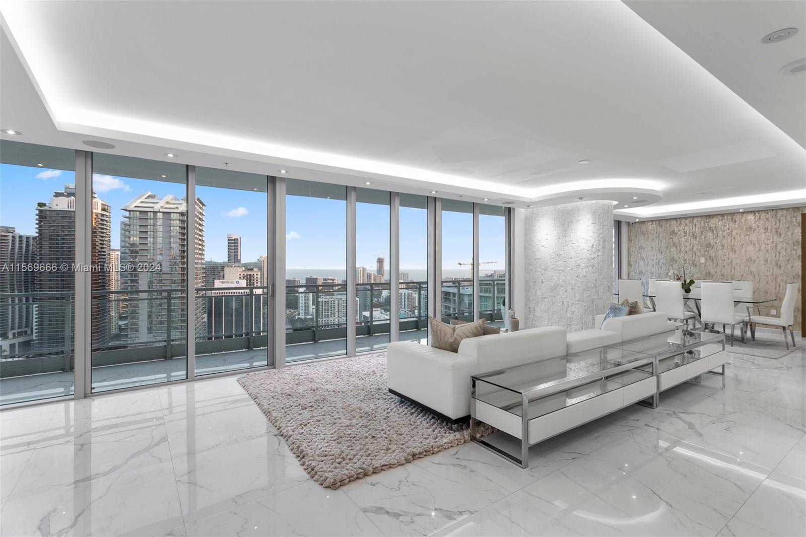 a living room with furniture and a floor to ceiling window