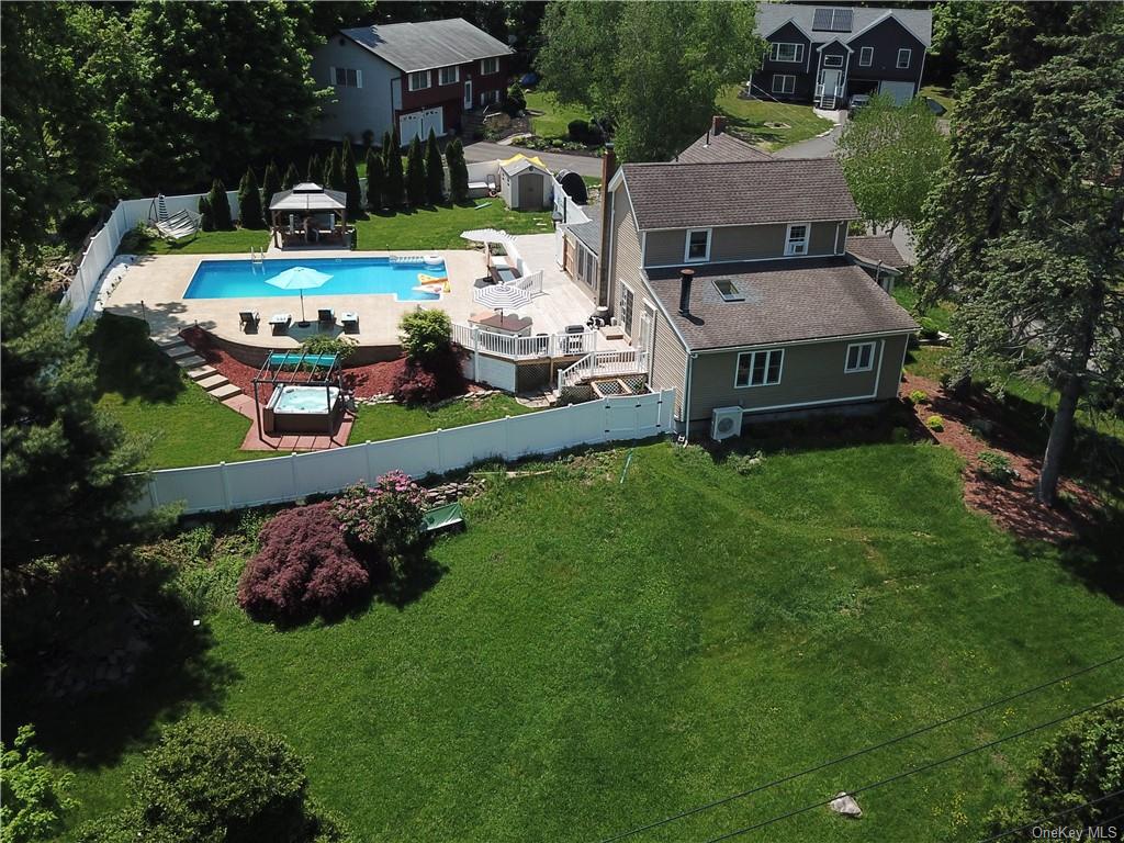 an aerial view of a house with garden space a house swimming pool and outdoor seating