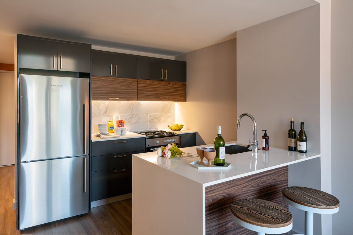 a kitchen with a refrigerator and a sink