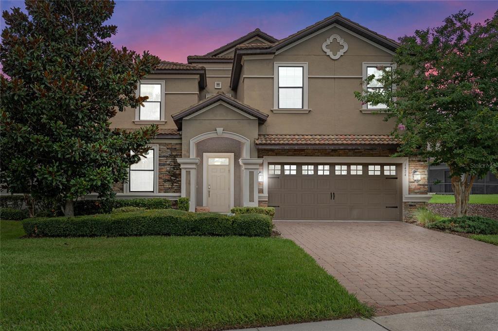 a front view of a house with a yard and garage