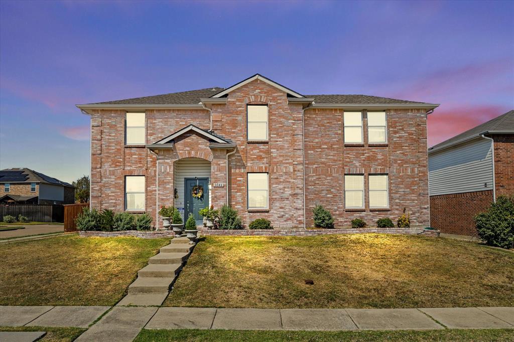 a front view of a house with yard