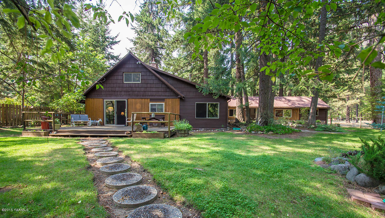 a front view of a house with swimming pool having outdoor seating