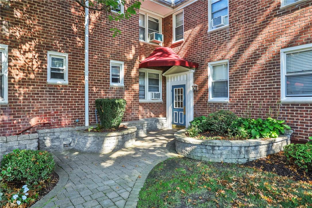 Entrance to property with a patio and cooling unit