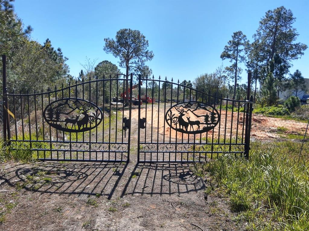 a view of a backyard with a iron fence