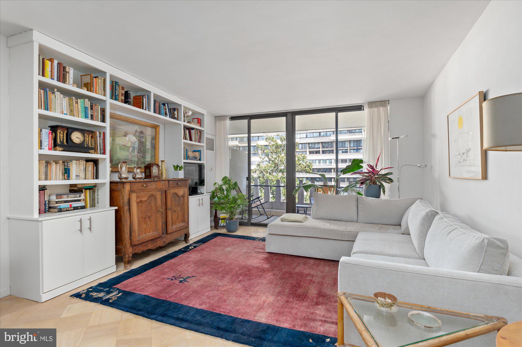 a living room with furniture and a book shelf